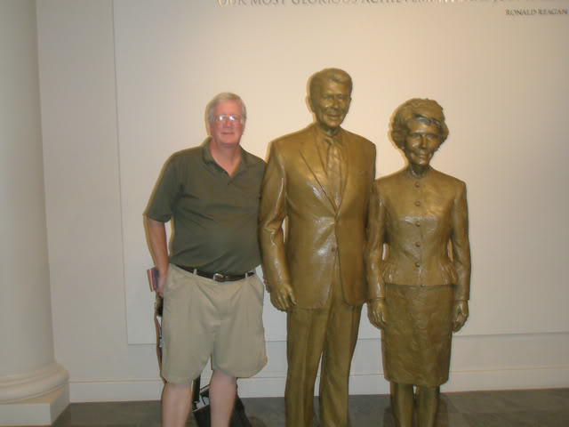 David poses with the bronze Reagans