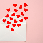 Envelope with red paper hearts
